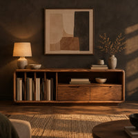 Low tv stand with vertical slots, an open shelf and two drawers in a dark living room at golden hour