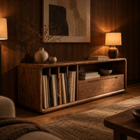 Low tv stand with vertical slots, an open shelf and two drawers in an evening living room with walnut wall paneling