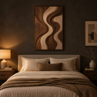 Wall art panel with flowing wave bands in dark and pale wood above a bed in a dusk lit bedroom