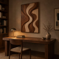 Wall art panel with flowing wave bands in dark and pale wood above a desk in a dark study corner