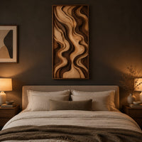 Tall framed wall art with layered wave relief in light and dark wood above a bed in a dusk lit bedroom