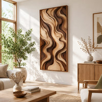 Tall framed wall art with layered wave relief in light and dark wood in a bright sunroom with green plants