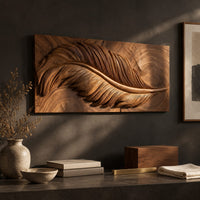 Detail of carved wood wall art panel with a large feather in deep relief beside wood, brass and linen samples