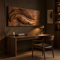 Carved wood wall art panel with a large feather in deep relief above a desk in a dark study corner