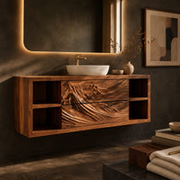 Corner detail of wall mounted bathroom vanity with carved mountain ridge fronts and open cubbies beside wood, brass and linen samples