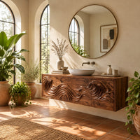 Wall mounted bathroom vanity with rolling wave carving in a bright bathroom with arched windows and plants