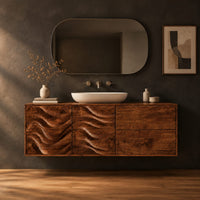 Wall mounted bathroom vanity with wave carved doors in a dark studio against a charcoal plaster wall