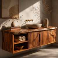 Corner detail of wall mounted bathroom vanity with a live edge top and leaf carved fronts beside wood, brass and linen samples