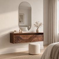 Floating makeup vanity with an open top niche and a wave carved front in a Scandinavian bedroom with white walls