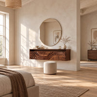 Floating makeup vanity with an open top niche and a wave carved front in a bright open plan bedroom