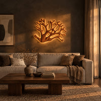 Wall sconce shaped like branching coral with open carved limbs in a dark living room at golden hour