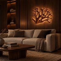 Wall sconce shaped like branching coral with open carved limbs in an evening living room with walnut wall paneling