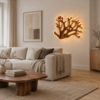 Wall sconce shaped like branching coral with open carved limbs in a Scandinavian living room with white walls