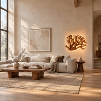 Wall sconce shaped like branching coral with open carved limbs in a bright open plan living room