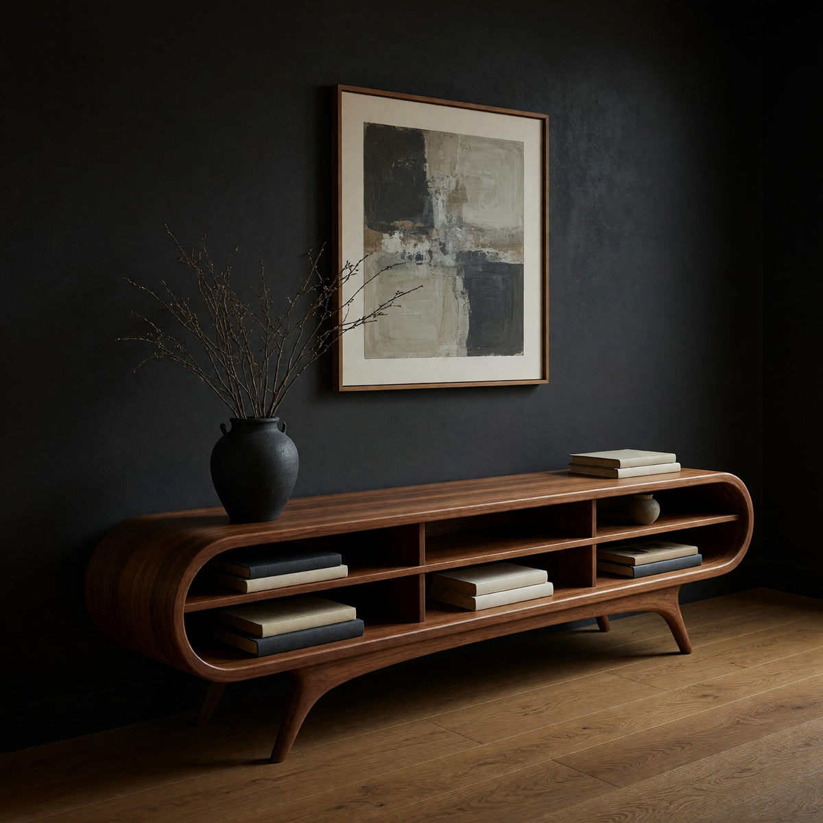 Warm grain capsule TV cabinet on splayed legs in a dark studio against a charcoal wall