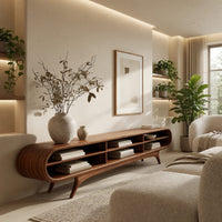 Warm grain capsule TV cabinet on splayed legs in a sunlit room with large windows and plants
