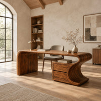Sculpted wood desk with a waterfall side panel and a two drawer pedestal in a bright open plan home office