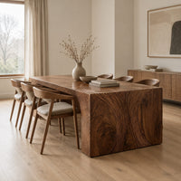 Waterfall dining table with carved swirl grain end panels in a Scandinavian dining room with white walls