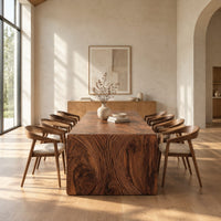 Waterfall dining table with carved swirl grain end panels in a bright open plan dining room