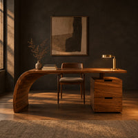Desk with a sweeping waterfall leg and a two drawer pedestal in a dark home office at golden hour