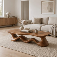 Coffee table with a freeform slab top on a rolling wave shaped base in a Scandinavian living room with white walls
