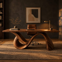 Rectangular desk on a single flowing wave shaped wood base in a dark home office at golden hour