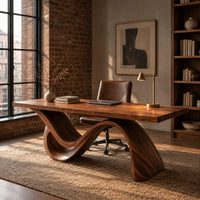Rectangular desk on a single flowing wave shaped wood base in an industrial loft home office with exposed brick