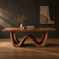 Rectangular dining table with a wave shaped base and open arch ends in a dark studio against a charcoal plaster wall