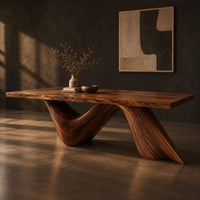 Rectangular dining table with a thick slab top on two ribbon like wave legs, three-quarter view showing the grain