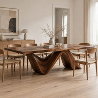 Rectangular dining table with a thick slab top on two ribbon like wave legs in a Scandinavian dining room with white walls