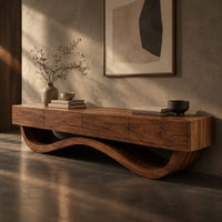 Corner detail of long tv stand with four flush front panels on a wave shaped base beside wood, brass and linen samples