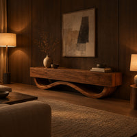 Long tv stand with four flush front panels on a wave shaped base in an evening living room with walnut wall paneling
