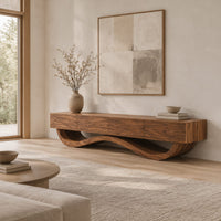 Long tv stand with four flush front panels on a wave shaped base in a Scandinavian living room with white walls