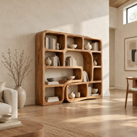Bookshelf with flowing wave dividers and open cubbies of mixed sizes in a bright open plan living room