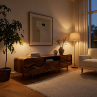 Mid century TV cabinet with wave carved doors in an evening room lit by two lamps