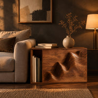 End table with a carved wave front and an open side compartment in a dark living room at golden hour