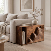 End table with a carved wave front and an open side compartment in a Scandinavian living room with white walls