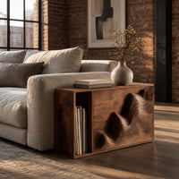 End table with a carved wave front and an open side compartment in an industrial loft living room with exposed brick