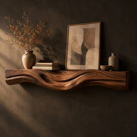 Thick wood fireplace mantel with a wave carved front and flowing grain, three-quarter view showing the grain