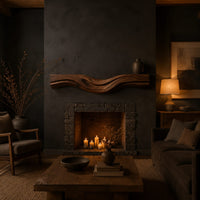 Thick wood fireplace mantel with a wave carved front and flowing grain in a dark living room at golden hour