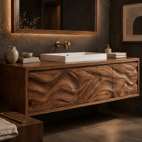 Corner detail of long floating bathroom vanity cabinet with three wave carved front panels beside wood, brass and linen samples