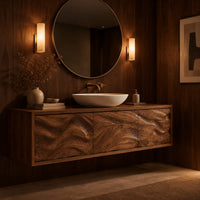 Long floating bathroom vanity cabinet with three wave carved front panels in an evening bathroom with walnut wall paneling