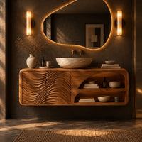 Floating bathroom vanity with wave carved doors and an open shelf bay in a dark bathroom at golden hour