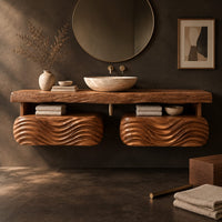 Corner detail of floating vanity with a thick slab top over two wave carved pods beside wood, brass and linen samples