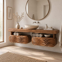 Floating vanity with a thick slab top over two wave carved pods in a Scandinavian bathroom with white walls