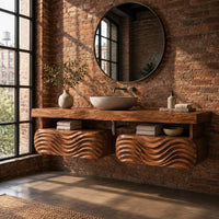 Floating vanity with a thick slab top over two wave carved pods in an industrial loft bathroom with exposed brick