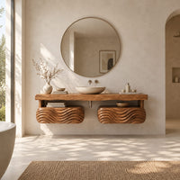 Floating vanity with a thick slab top over two wave carved pods in a bright open plan bathroom