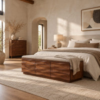 Bench with a padded seat and three wave carved front panels in a bright open plan bedroom