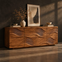 Wave carved wooden sideboard with four relief panels on a plinth base, three-quarter view showing the grain