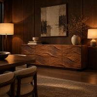Wave carved wooden sideboard with four relief panels on a plinth base in an evening dining room with walnut wall paneling